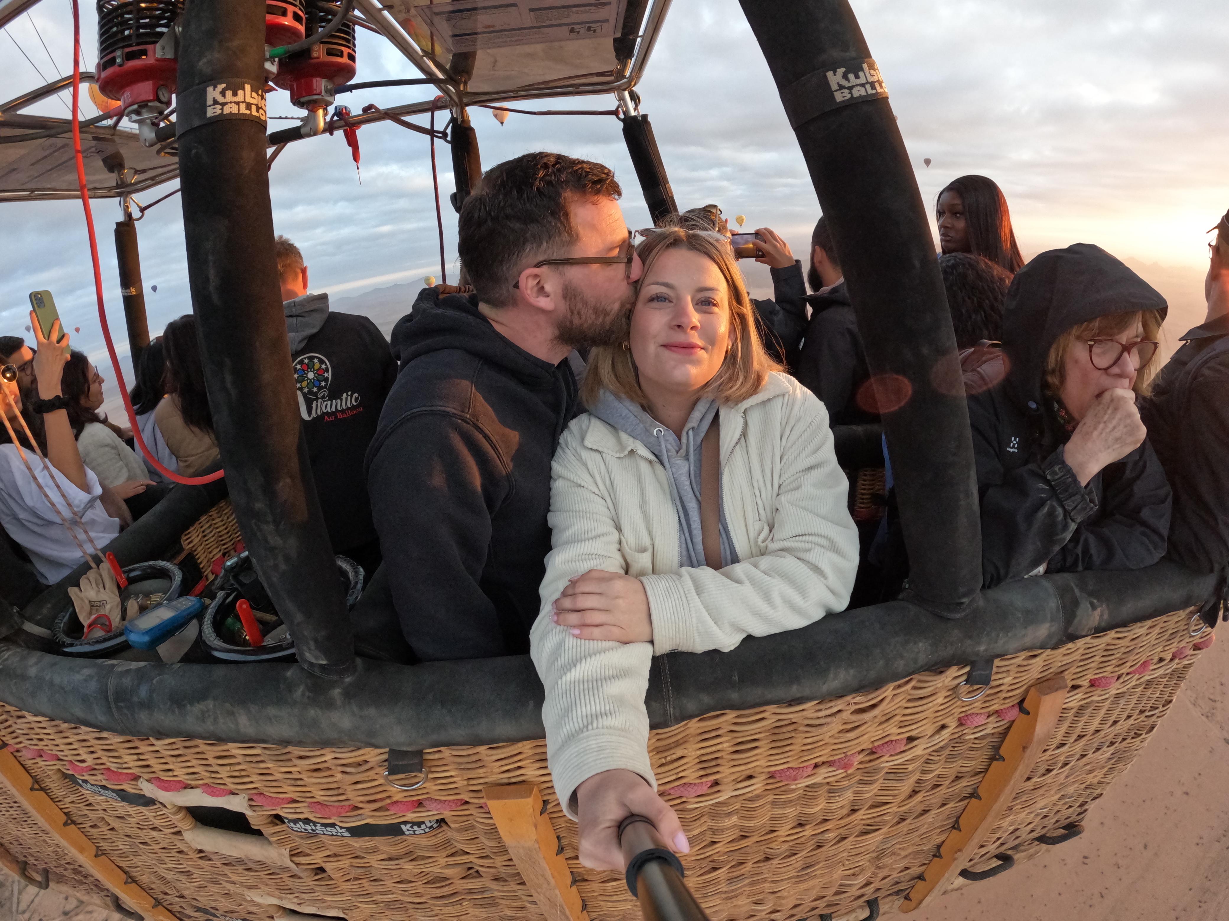 Guests in a hot air balloon basket above southern Morocco
