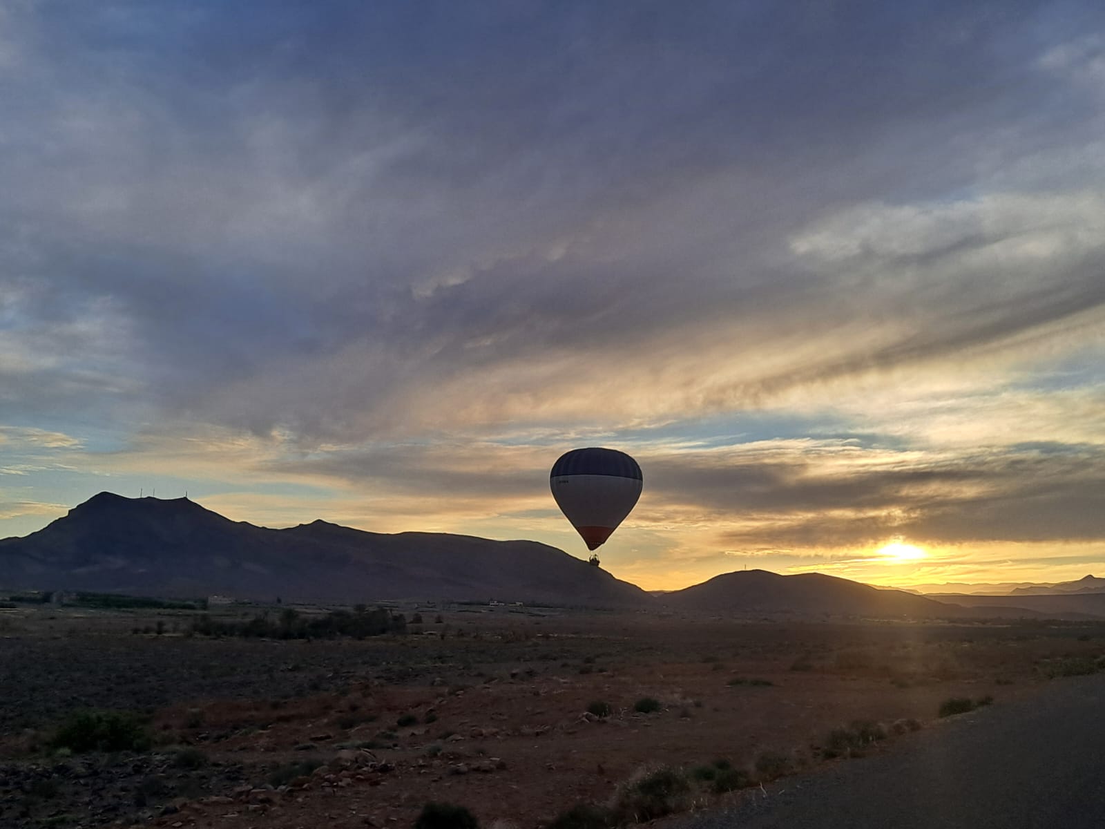 Sunrise balloon silhouette during a Moroccan hot air balloon journey